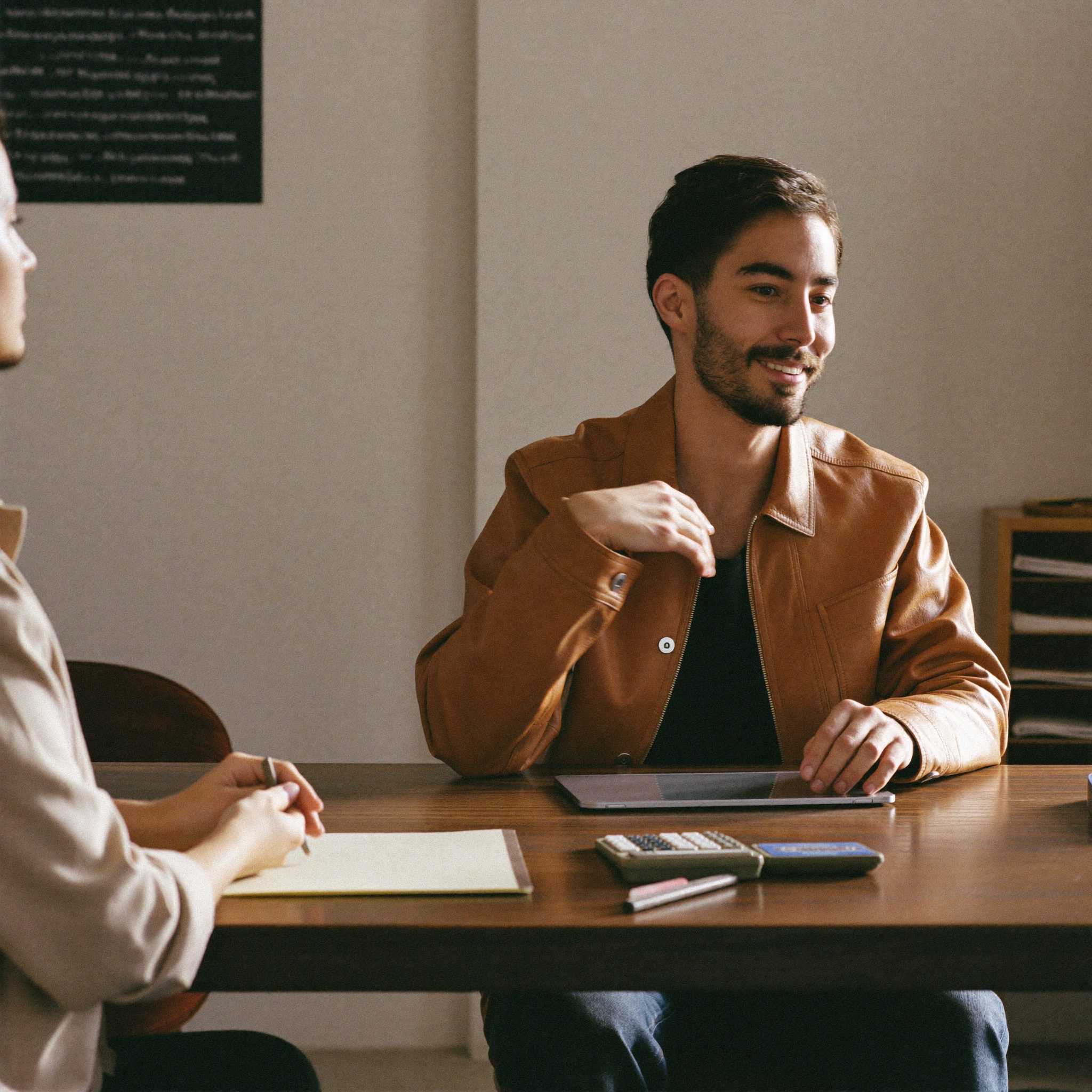 A HVR Ventures consultant reviewing figures with a client across a table